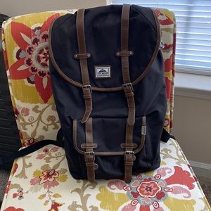 Steve Madden black backpack with brown leather strappings.